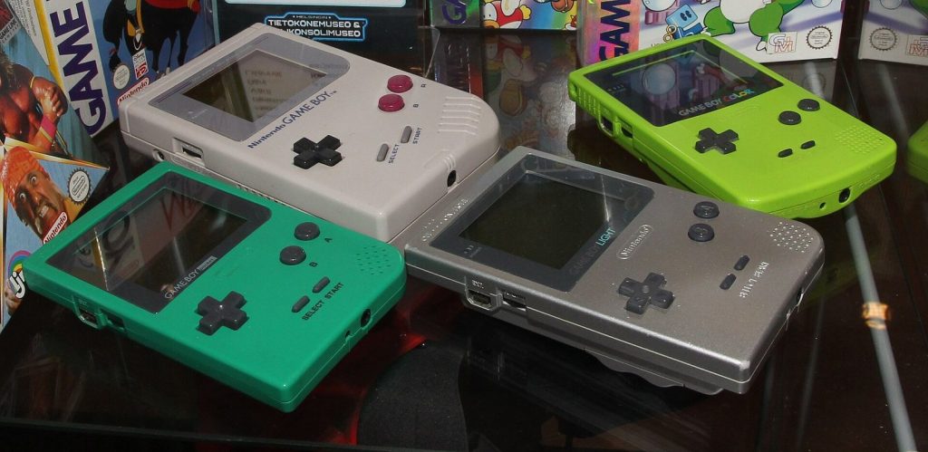 Game Boy, Game Boy Pocket, Game Boy Light and Game Boy Color side by side in a museum