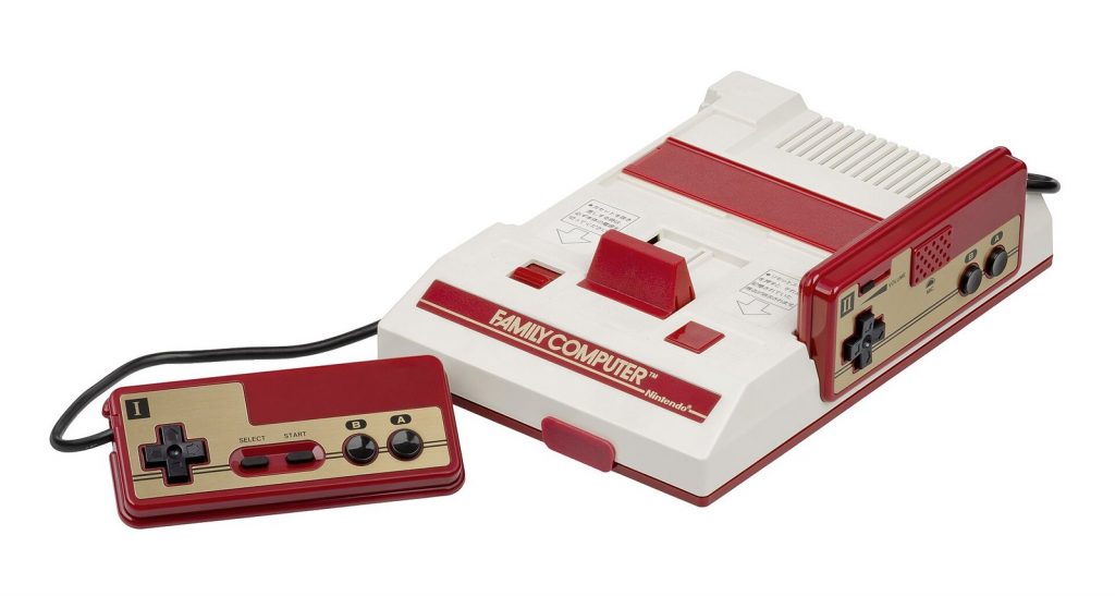 Red and white Nintendo Famicom with its two hardwired controllers