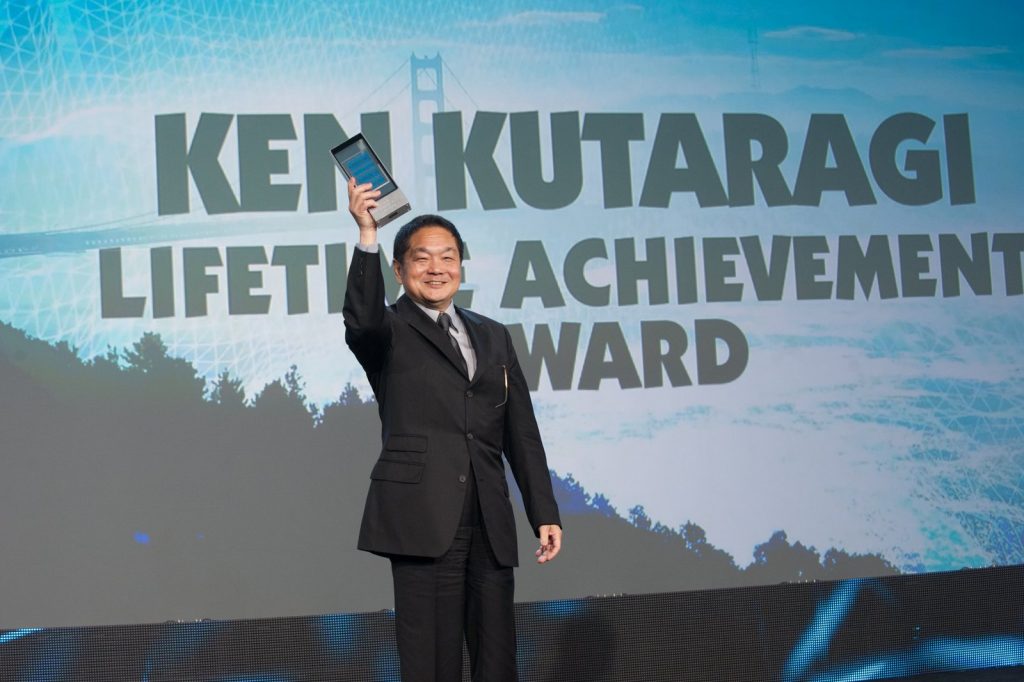 Ken Kutaragi accepting a Lifetime Achievement Award on stage