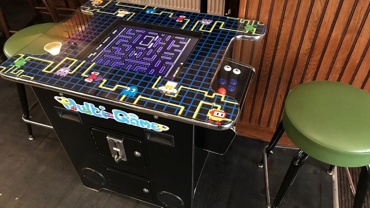 Pac-Man arcade machine with its cabinet artwork and screen