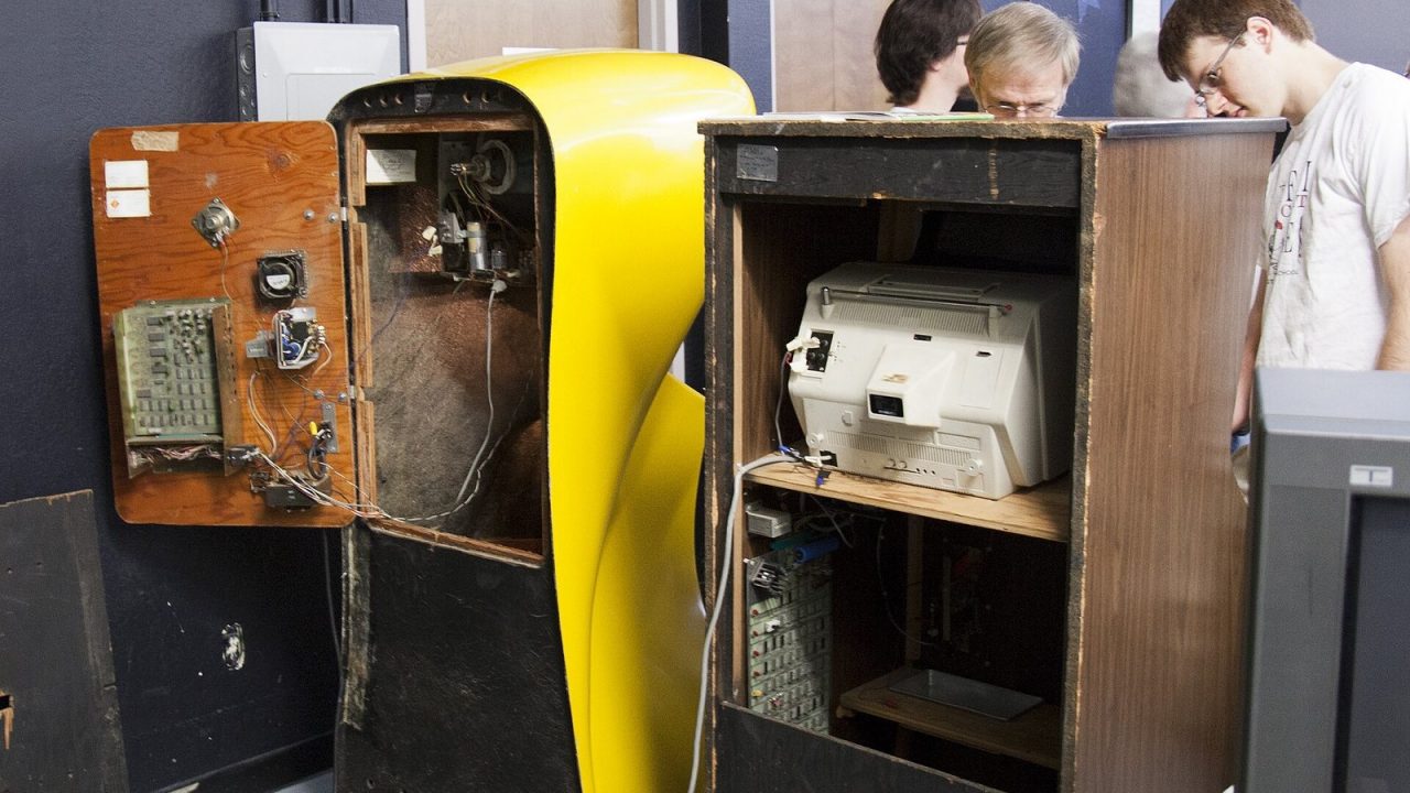 Opened backs of Pong and Computer Space arcade cabinets showing circuit boards and wiring