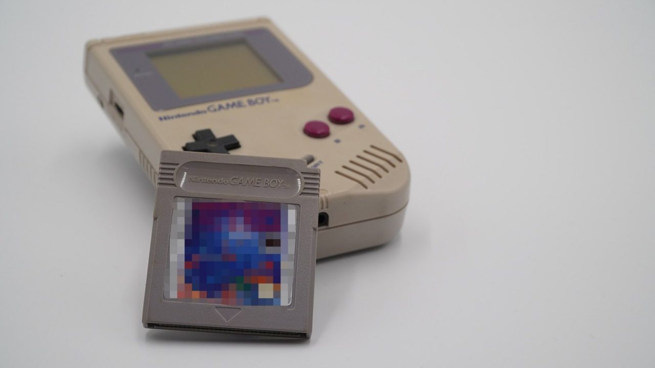 Nintendo Game Boy with a Tetris cartridge leaning against it