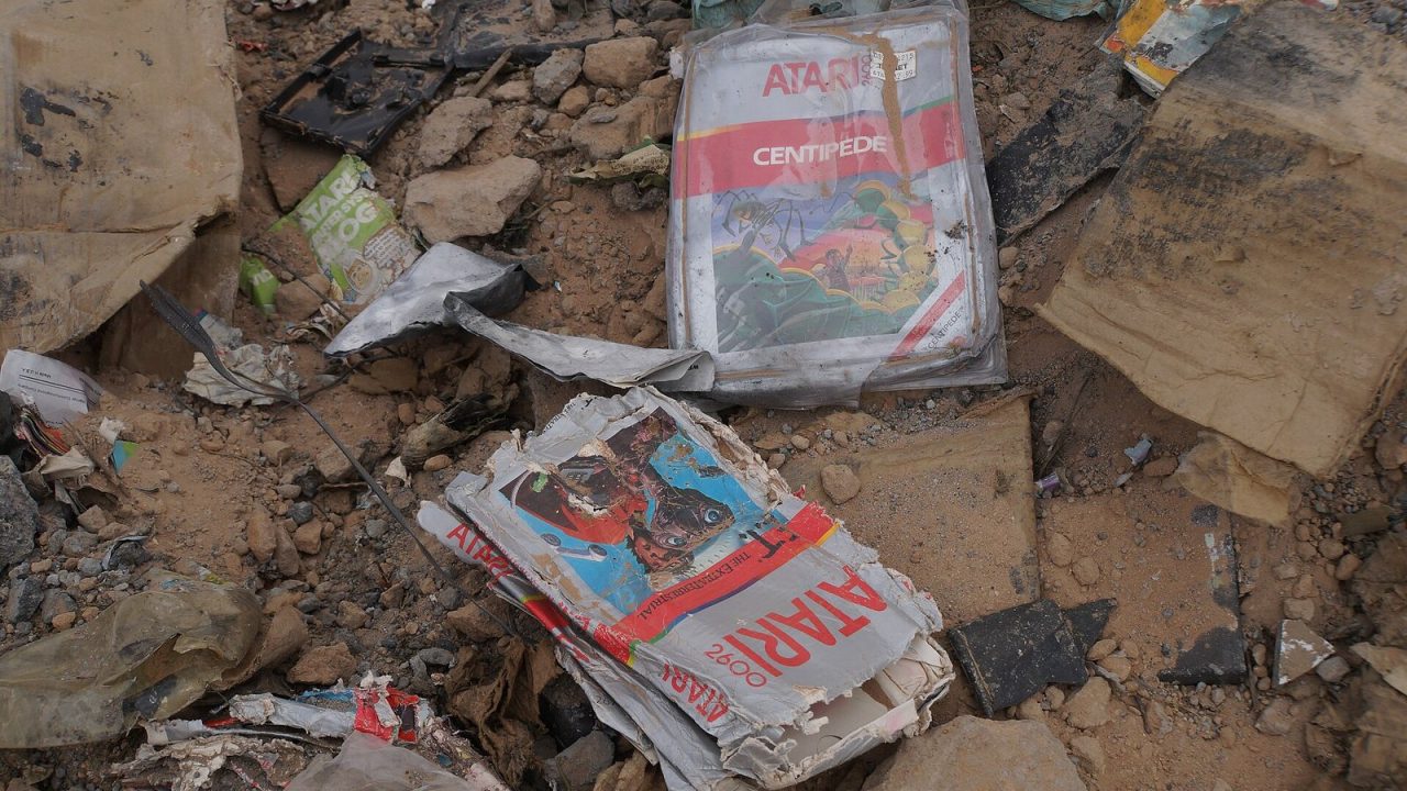 Dirt-covered E.T. and Centipede game boxes recovered from the Alamogordo landfill in 2014
